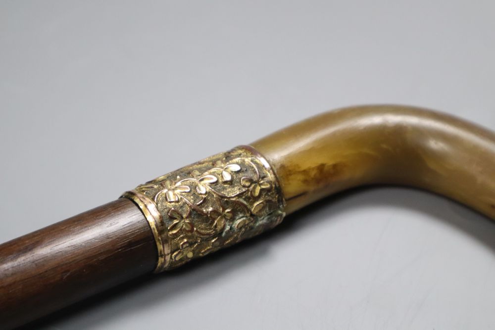 An Edwardian rhinoceros horn handled walking stick, presented 1906, length 88cm